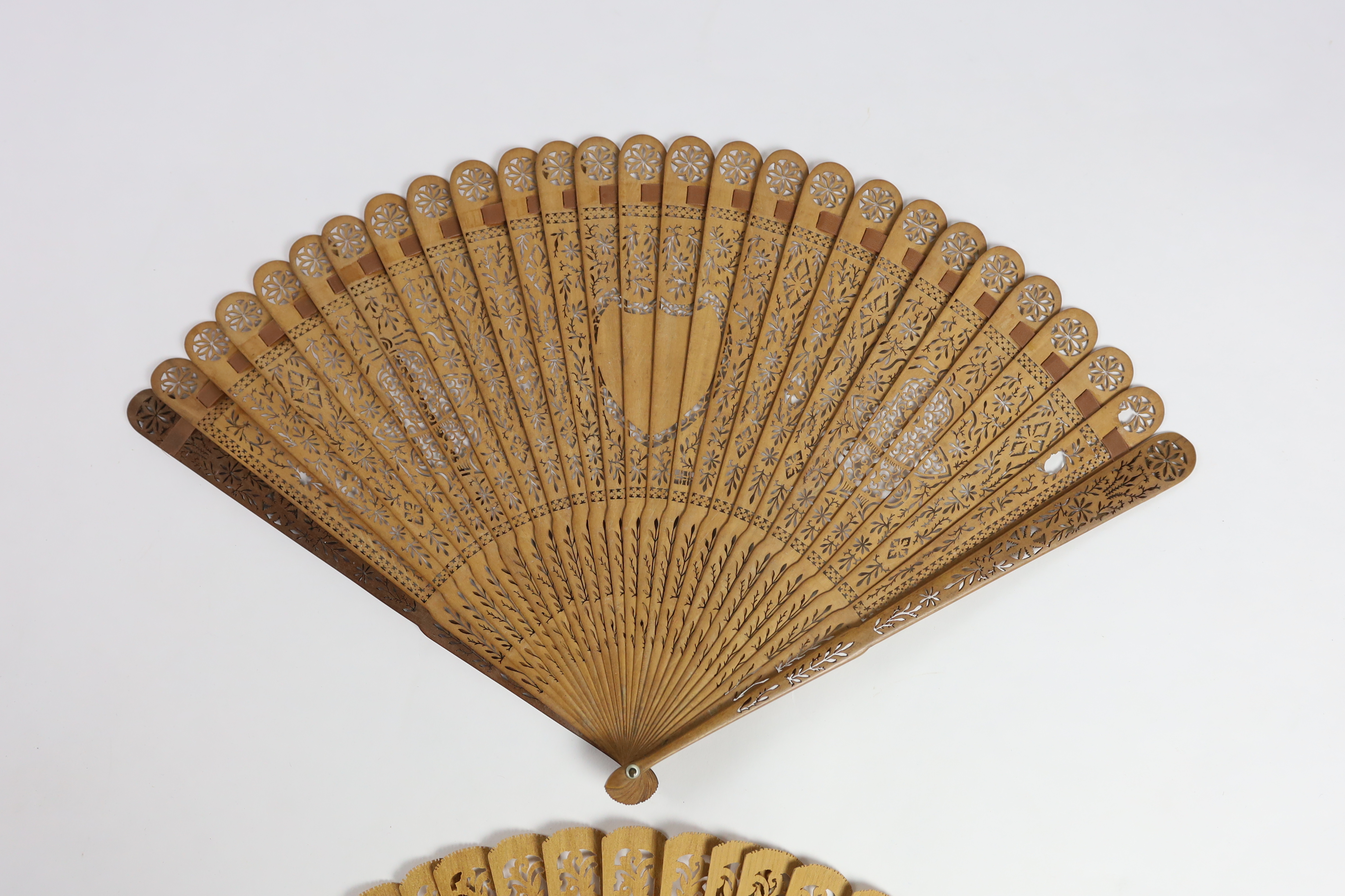 A 19th century Chinese sandalwood brisé fan and a smaller 20th century Chinese sandalwood fan